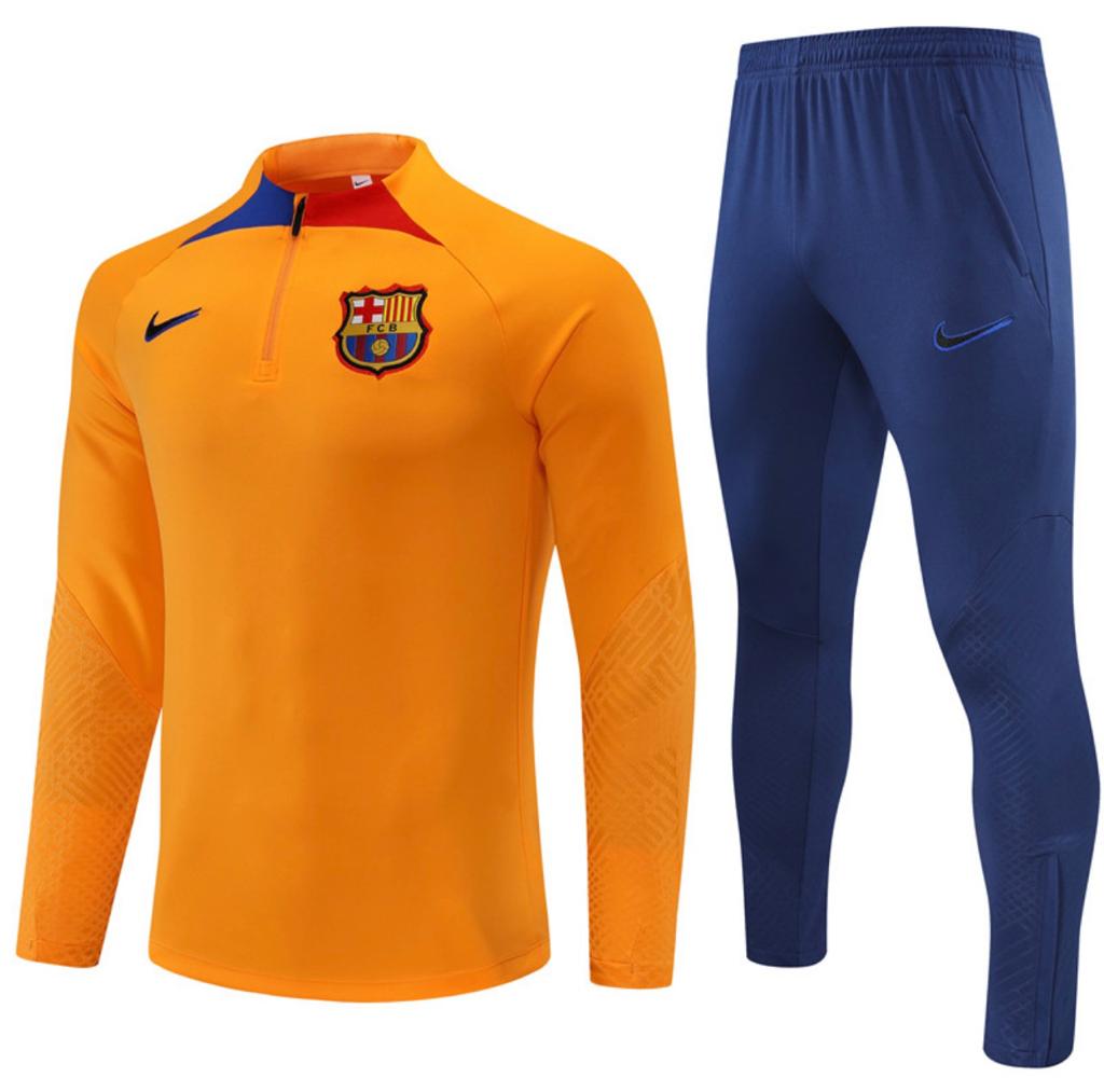 survetement-barcelone-orange-bleu SURVÊTEMENT FC BARCELONE EXTÉRIEUR 2022/2023 – Image 1